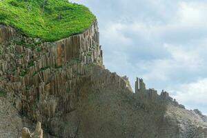 amazing landscape of columnar volcanic basalt rocks on the island of Kunashir photo