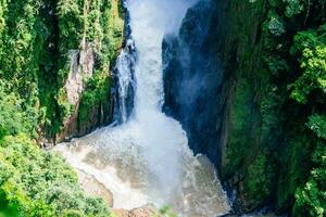 Waterfall in the mountains. Beautiful view of the mountain river. photo