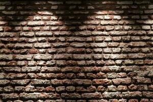 Red brick wall texture background with backlight photo