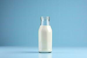 AI generated A glass bottle with full milk on blue background. AI Generated photo