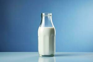 AI generated A glass bottle with full milk on blue background. AI Generated photo