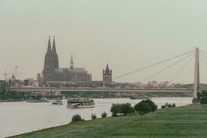 Cloudscape View of Cologne Cathedral and the Rhine River photo