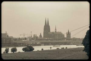 Cloudscape View of Cologne Cathedral and the Rhine River photo