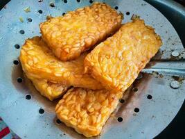 Tempe, Fried Tempe or Fried Tempe is a traditional Indonesian food made from fermented soybeans. Isolated background photo