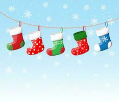 Christmas stockings in various colors on rope vector