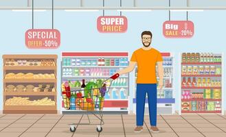 Young man pushing supermarket shopping cart full of groceries. Vector illustration in flat style