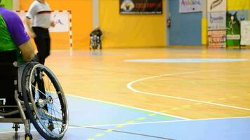 Malaga, Spain, 2018 - Player on the sidelines watching a game of wheelchair basketball video