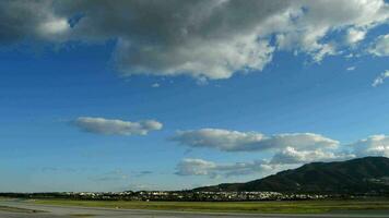 Airplane taking off from airport runway a cloudy day video