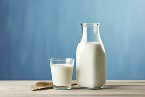 AI generated A bottle of milk and a glass of milk on a wooden table on a blue background. AI Generated photo