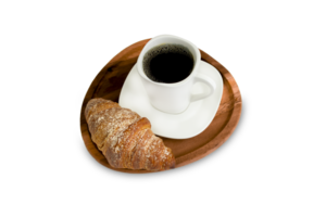 A cup of coffee with a croissant on a wooden board isolated on a transparent background. png