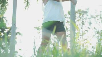 Athletic runner doing stretching exercise, preparing for running in the nature with the city in background. Healthy lifestyle video