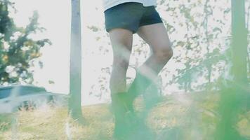 Athletic runner doing stretching exercise, preparing for running in the nature with the city in background. Healthy lifestyle video