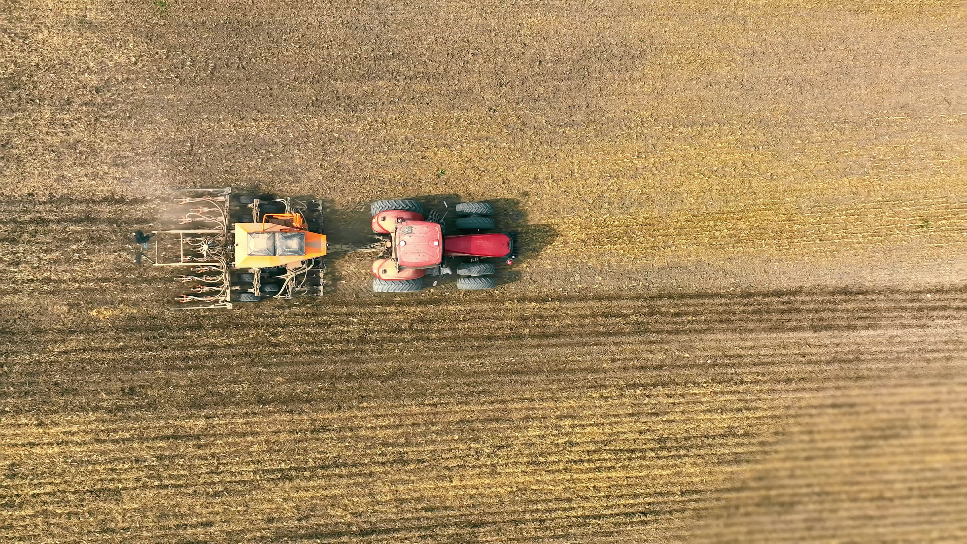 Aerial top view Tractor with plough on agricultural land, Tractor