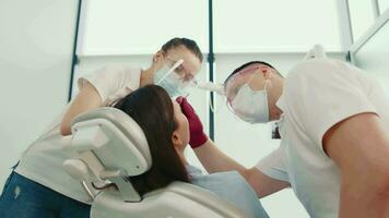 Dental Checkup in Modern Clinic, Dentist and assistant performing dental examination on patient. video