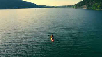 two in a canoe on a large lake. Resting by the lake and canoeing in the evening. video