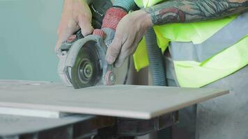 Cutting Tiles close-up with an Electric tile Cutter video