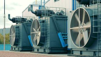 Operation of large industrial cooling fans. Large pumping station with cooling fans. Rotating rotating blades video