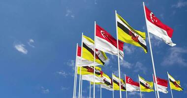 Brunei and Singapore Flags Waving Together in the Sky, Seamless Loop in Wind, Space on Left Side for Design or Information, 3D Rendering video