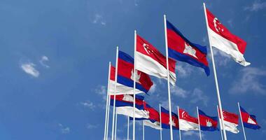 cambodia och singapore flaggor vinka tillsammans i de himmel, sömlös slinga i vind, Plats på vänster sida för design eller information, 3d tolkning video