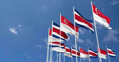 Costa Rica and Singapore Flags Waving Together in the Sky, Seamless Loop in Wind, Space on Left Side for Design or Information, 3D Rendering video