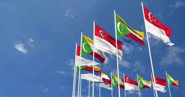 Comoros and Singapore Flags Waving Together in the Sky, Seamless Loop in Wind, Space on Left Side for Design or Information, 3D Rendering video
