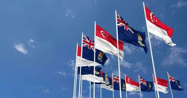 Cayman Islands and Singapore Flags Waving Together in the Sky, Seamless Loop in Wind, Space on Left Side for Design or Information, 3D Rendering video