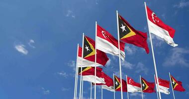 East Timor and Singapore Flags Waving Together in the Sky, Seamless Loop in Wind, Space on Left Side for Design or Information, 3D Rendering video