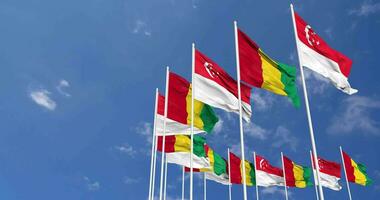 Guinea and Singapore Flags Waving Together in the Sky, Seamless Loop in Wind, Space on Left Side for Design or Information, 3D Rendering video