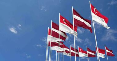 Latvia and Singapore Flags Waving Together in the Sky, Seamless Loop in Wind, Space on Left Side for Design or Information, 3D Rendering video