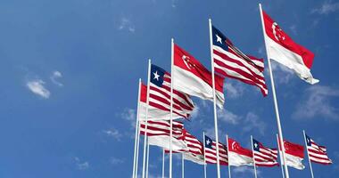 Liberia and Singapore Flags Waving Together in the Sky, Seamless Loop in Wind, Space on Left Side for Design or Information, 3D Rendering video