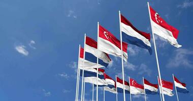 Pays-Bas et Singapour drapeaux agitant ensemble dans le ciel, sans couture boucle dans vent, espace sur la gauche côté pour conception ou information, 3d le rendu video