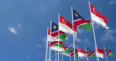 Namibia and Singapore Flags Waving Together in the Sky, Seamless Loop in Wind, Space on Left Side for Design or Information, 3D Rendering video