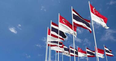 Thailand and Singapore Flags Waving Together in the Sky, Seamless Loop in Wind, Space on Left Side for Design or Information, 3D Rendering video