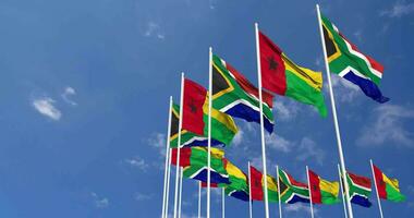 Guinea Bissau and South Africa Flags Waving Together in the Sky, Seamless Loop in Wind, Space on Left Side for Design or Information, 3D Rendering video