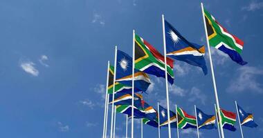 Marshall Islands and South Africa Flags Waving Together in the Sky, Seamless Loop in Wind, Space on Left Side for Design or Information, 3D Rendering video