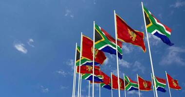 Montenegro and South Africa Flags Waving Together in the Sky, Seamless Loop in Wind, Space on Left Side for Design or Information, 3D Rendering video