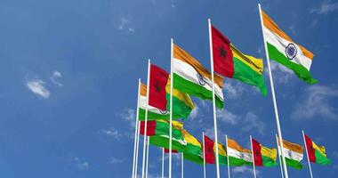 Guinea Bissau and India Flags Waving Together in the Sky, Seamless Loop in Wind, Space on Left Side for Design or Information, 3D Rendering video