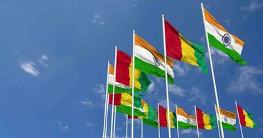 Guinea and India Flags Waving Together in the Sky, Seamless Loop in Wind, Space on Left Side for Design or Information, 3D Rendering video