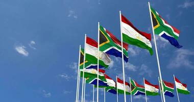 Tajikistan and South Africa Flags Waving Together in the Sky, Seamless Loop in Wind, Space on Left Side for Design or Information, 3D Rendering video