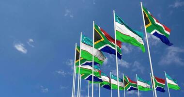 Uzbekistan and South Africa Flags Waving Together in the Sky, Seamless Loop in Wind, Space on Left Side for Design or Information, 3D Rendering video