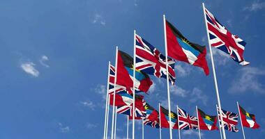 Antigua and Barbuda and United Kingdom Flags Waving Together in the Sky, Seamless Loop in Wind, Space on Left Side for Design or Information, 3D Rendering video