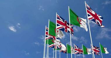 Algeria and United Kingdom Flags Waving Together in the Sky, Seamless Loop in Wind, Space on Left Side for Design or Information, 3D Rendering video