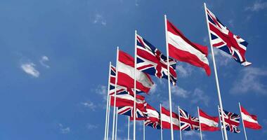 Austria and United Kingdom Flags Waving Together in the Sky, Seamless Loop in Wind, Space on Left Side for Design or Information, 3D Rendering video