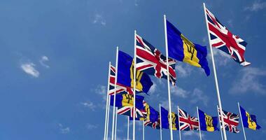 Barbados and United Kingdom Flags Waving Together in the Sky, Seamless Loop in Wind, Space on Left Side for Design or Information, 3D Rendering video