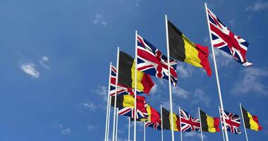 Belgium and United Kingdom Flags Waving Together in the Sky, Seamless Loop in Wind, Space on Left Side for Design or Information, 3D Rendering video