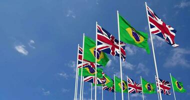 Brazil and United Kingdom Flags Waving Together in the Sky, Seamless Loop in Wind, Space on Left Side for Design or Information, 3D Rendering video