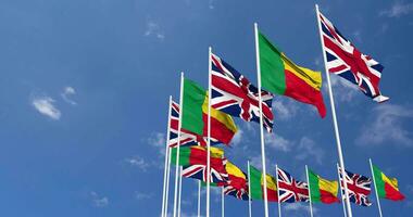 Benin and United Kingdom Flags Waving Together in the Sky, Seamless Loop in Wind, Space on Left Side for Design or Information, 3D Rendering video