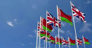 Belarus and United Kingdom Flags Waving Together in the Sky, Seamless Loop in Wind, Space on Left Side for Design or Information, 3D Rendering video