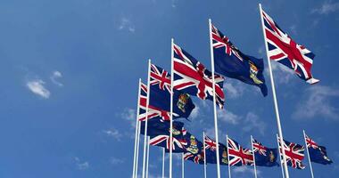 Cayman Islands and United Kingdom Flags Waving Together in the Sky, Seamless Loop in Wind, Space on Left Side for Design or Information, 3D Rendering video