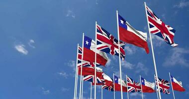 Chile and United Kingdom Flags Waving Together in the Sky, Seamless Loop in Wind, Space on Left Side for Design or Information, 3D Rendering video